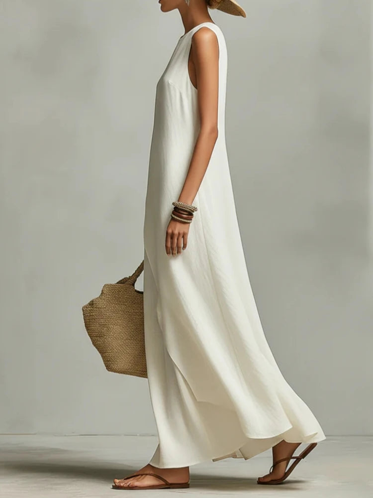 Light cream sleeveless maxi dress with side drape overlay and flowing skirt