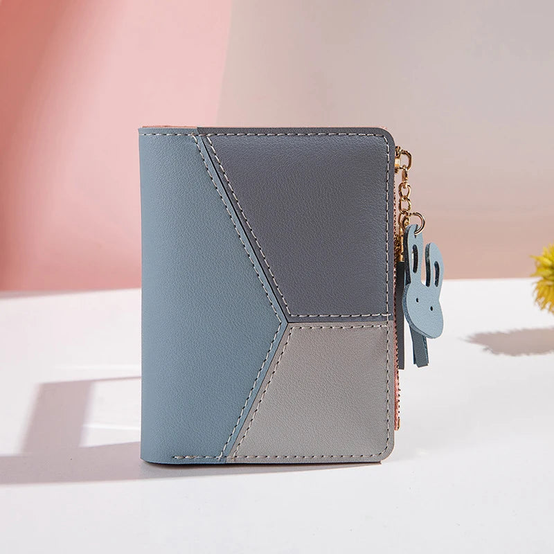 Blue compact PU leather wallet with stitched panels and dangling keyring charm