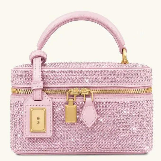 Pink textured leather crossbody commuter bag with top handle and gold zip closure