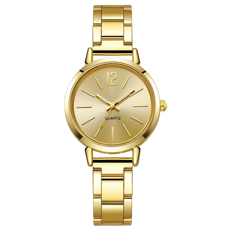 Women's quartz wristwatch with gold circular dial, Roman numerals, and metal link bracelet.