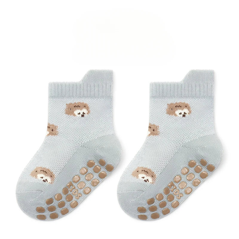Pair of non-slip baby floor socks in light blue with hedgehog print and grippy dots