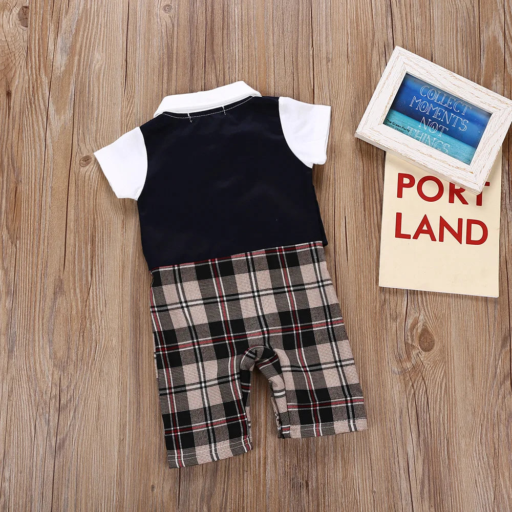 Infant boys’ gentleman suit romper with dark navy vest and plaid shorts