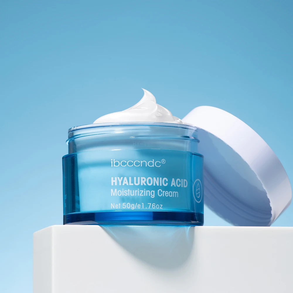 Blue skincare cream jar with open lid and visible white cream