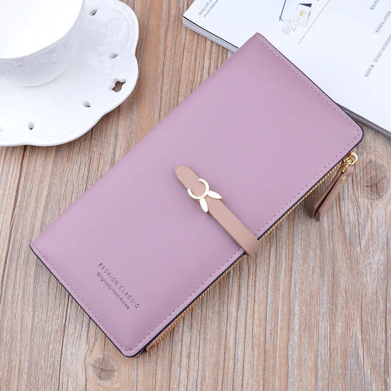 Long women's wallet purse, mauve with gold zipper and bow charm, front view