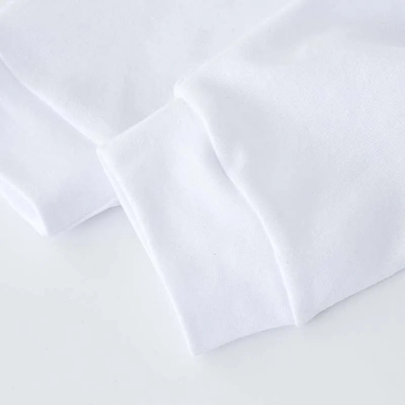 White baby jogger pants with stitched seams and gentle fabric drape