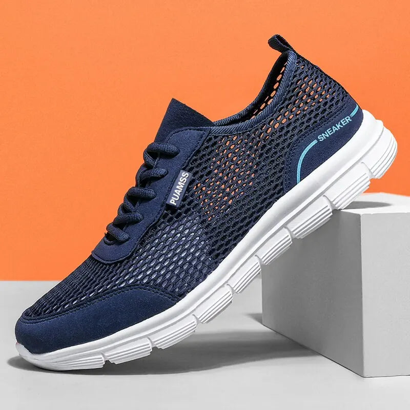 Navy blue mesh lace-up sneaker with white ribbed sole on a box