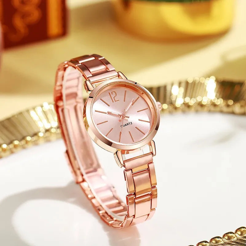 Women's quartz wristwatch with rose-gold circular dial, slim hands, and link bracelet.